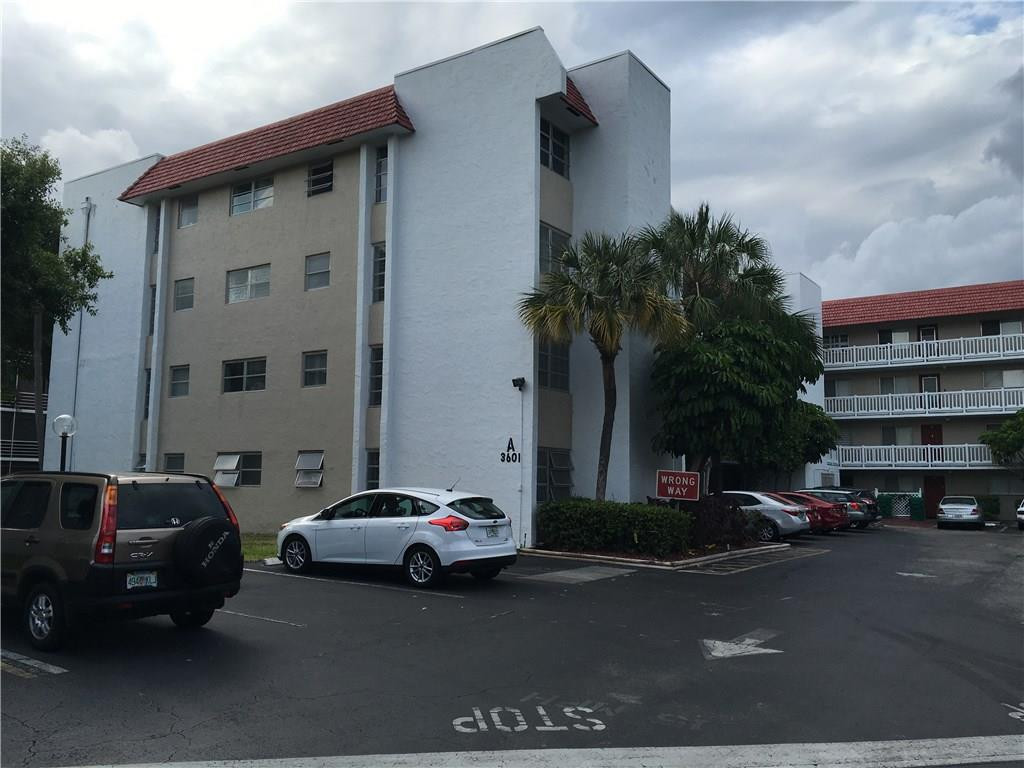 a couple of cars parked in front of a house