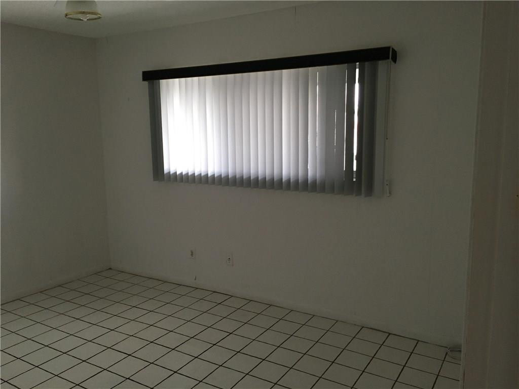 3601 Inverrary Drive, Unit 402 Lauderhill, FL 33319 - Photo 12 of 14 an empty room with windows