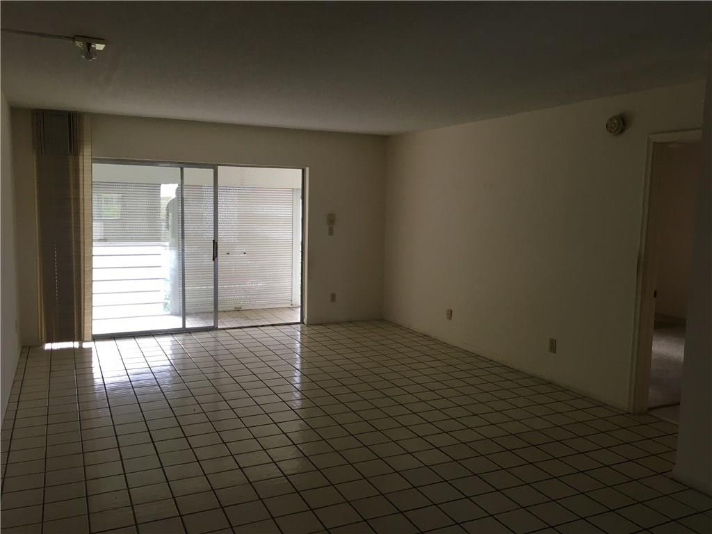 3601 Inverrary Drive, Unit 402 Lauderhill, FL 33319 - Photo 7 of 14 an empty room with wooden floor and windows