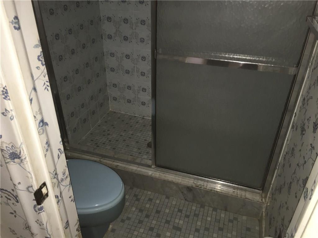 3601 Inverrary Drive, Unit 402 Lauderhill, FL 33319 - Photo 9 of 14 a bathroom with a granite countertop shower and a sink