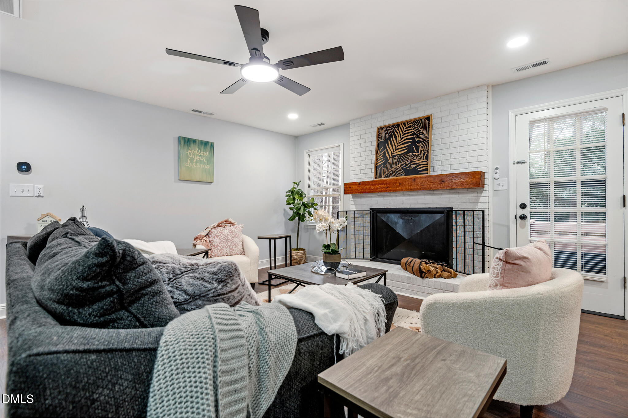 6604 Winding Trail Raleigh, NC 27612 - Photo 12 of 49 a living room with furniture a fireplace and a flat screen tv
