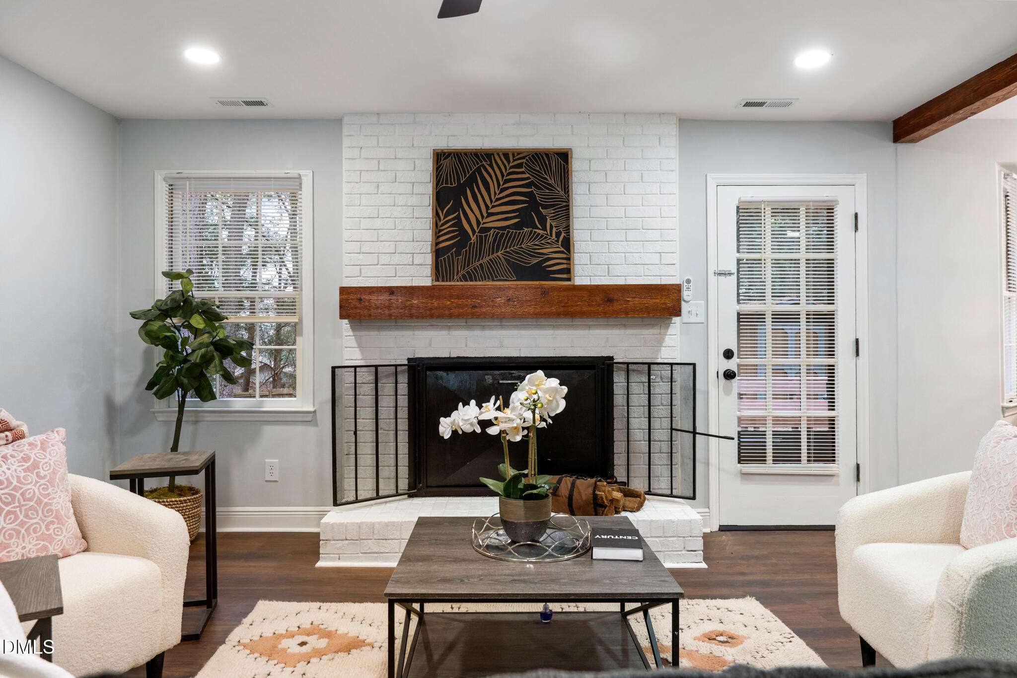6604 Winding Trail Raleigh, NC 27612 - Photo 15 of 49 a living room with furniture potted plant and a fireplace