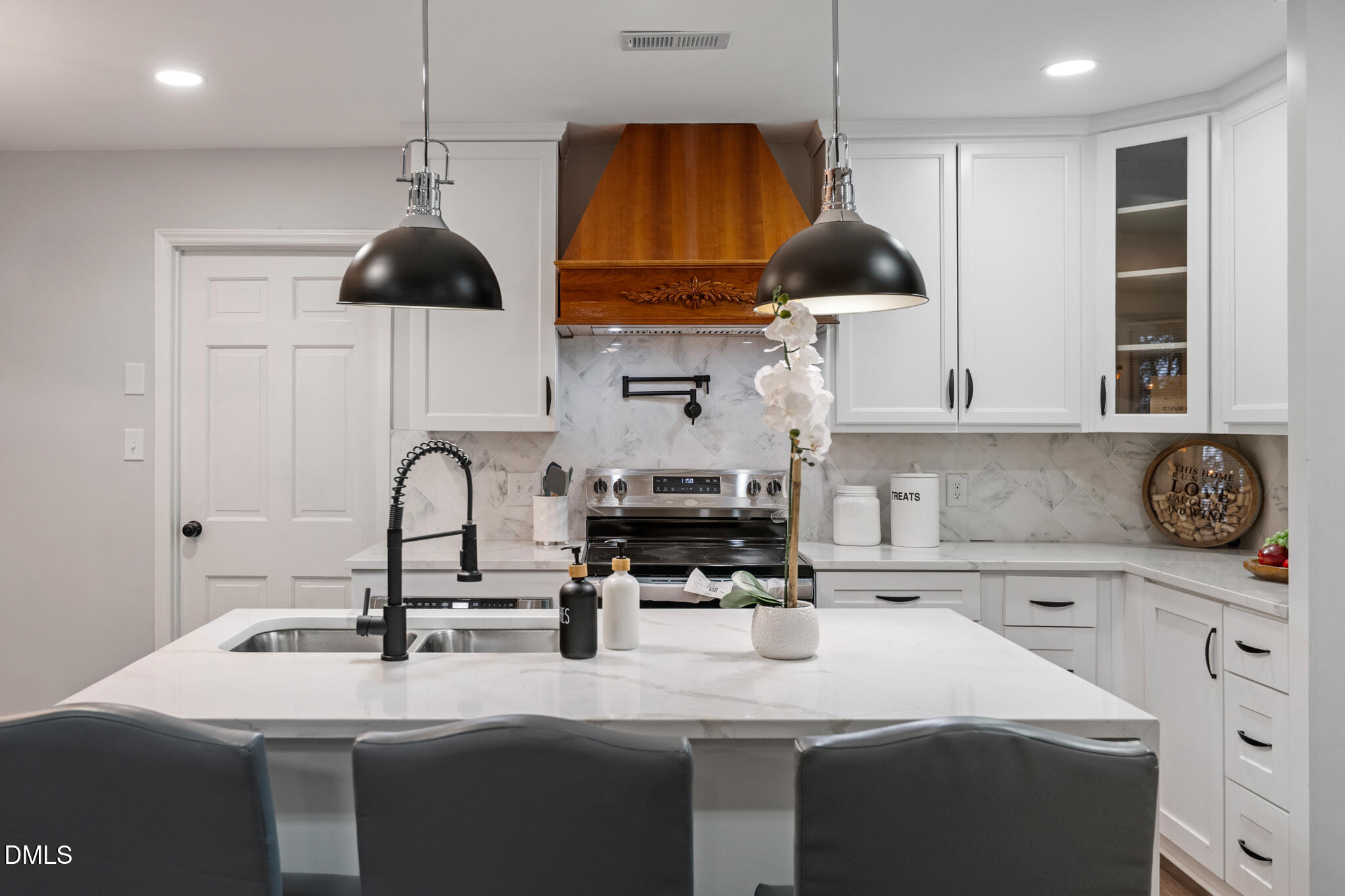 6604 Winding Trail Raleigh, NC 27612 - Photo 19 of 49 a kitchen with stainless steel appliances a sink a stove a counter space and cabinets