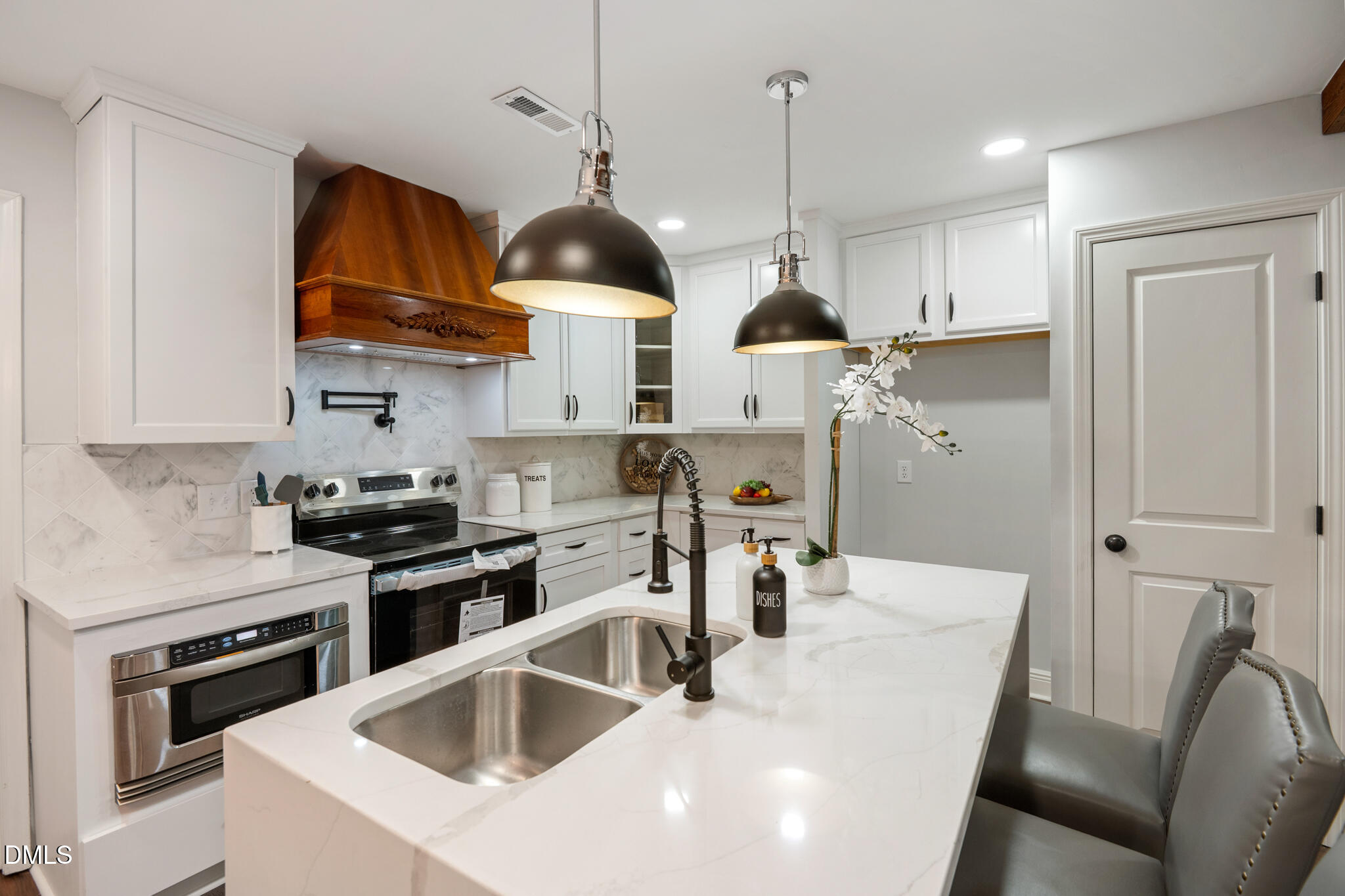 6604 Winding Trail Raleigh, NC 27612 - Photo 20 of 49 a kitchen with stainless steel appliances granite countertop a sink a stove and a refrigerator