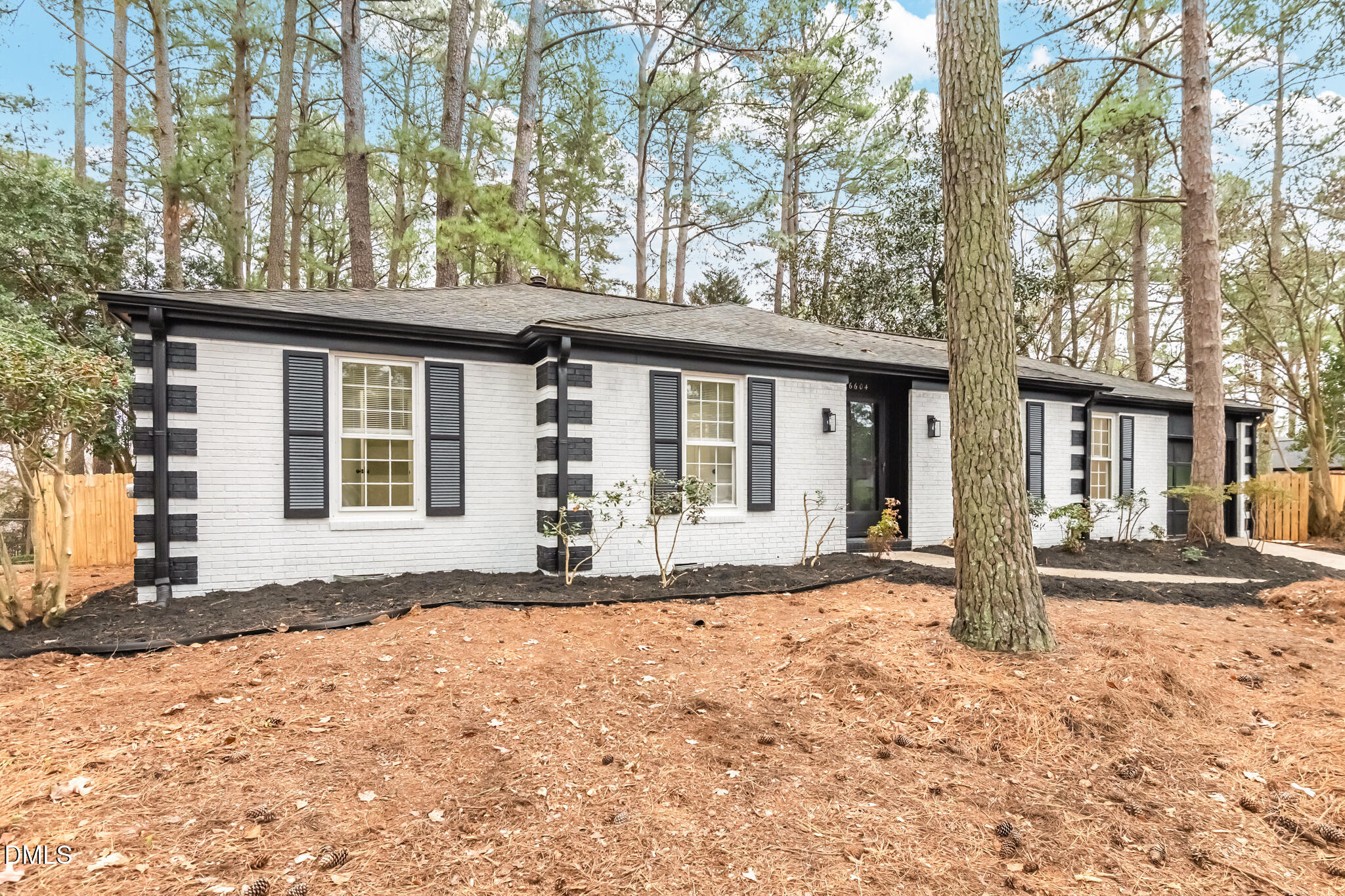 6604 Winding Trail Raleigh, NC 27612 - Photo 2 of 49 a front view of a house with a yard and potted plants