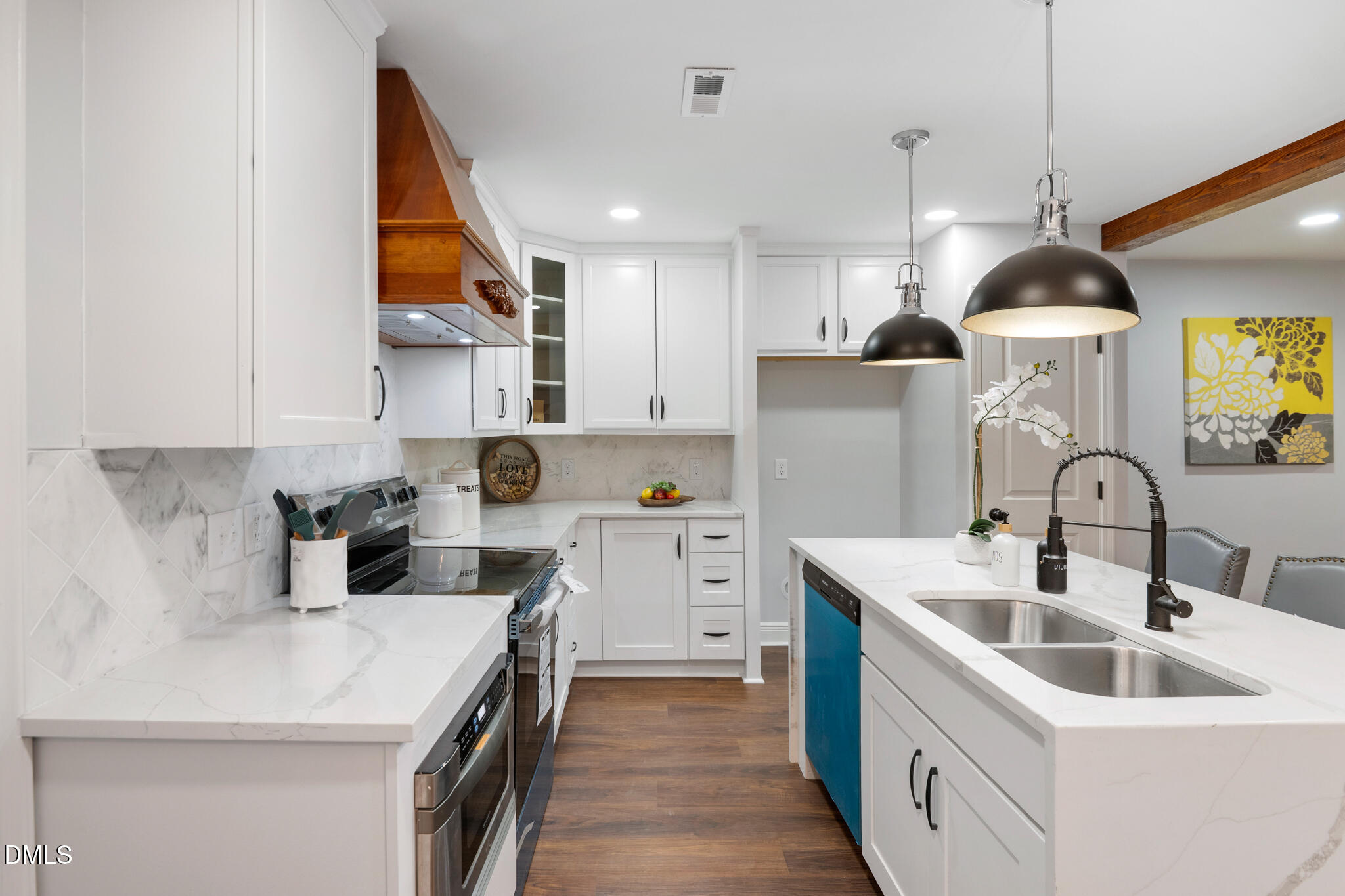 6604 Winding Trail Raleigh, NC 27612 - Photo 22 of 49 a kitchen with a sink a counter top space stainless steel appliances and cabinets
