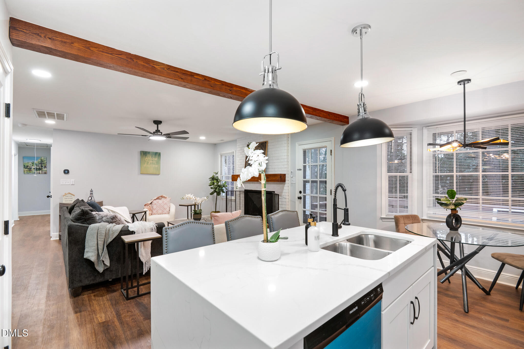 6604 Winding Trail Raleigh, NC 27612 - Photo 23 of 49 a very nice looking dining room with a large window a table chairs and a wooden floor