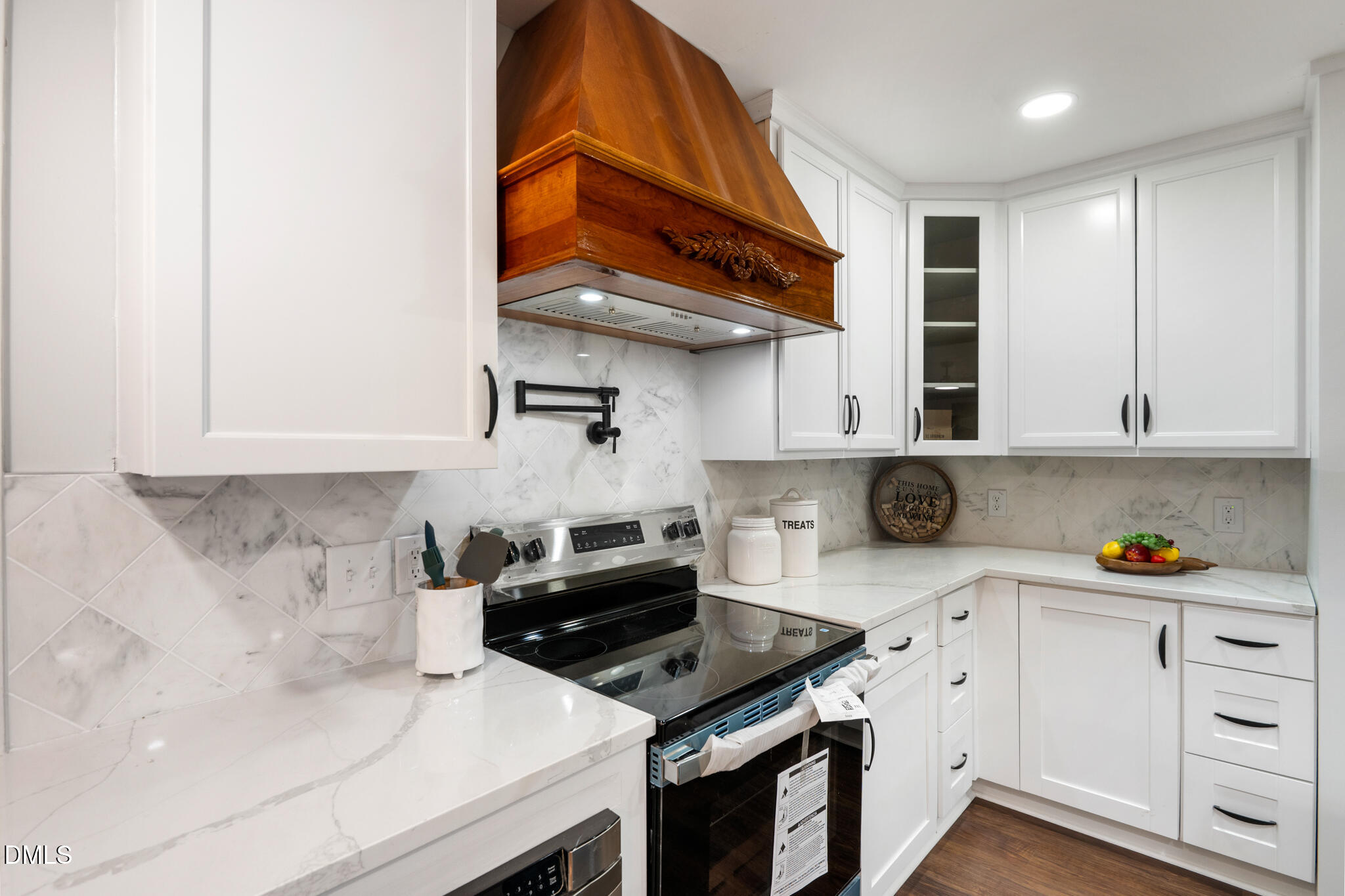 6604 Winding Trail Raleigh, NC 27612 - Photo 24 of 49 a kitchen with stainless steel appliances a stove a sink and cabinets