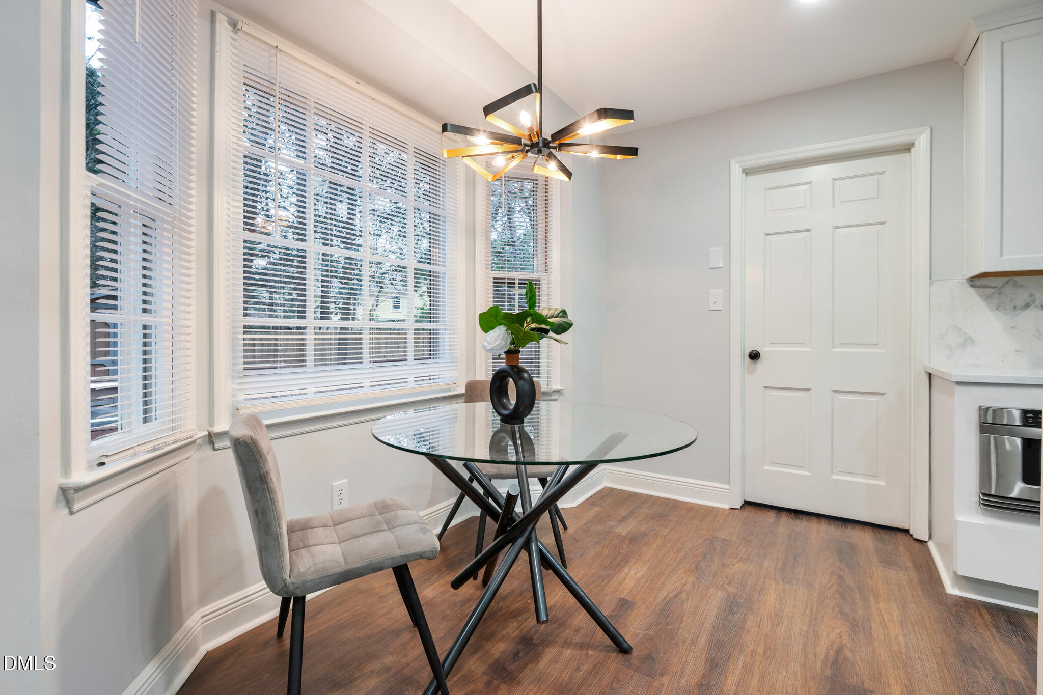 6604 Winding Trail Raleigh, NC 27612 - Photo 25 of 49 a view of a dining room with furniture window and wooden floor