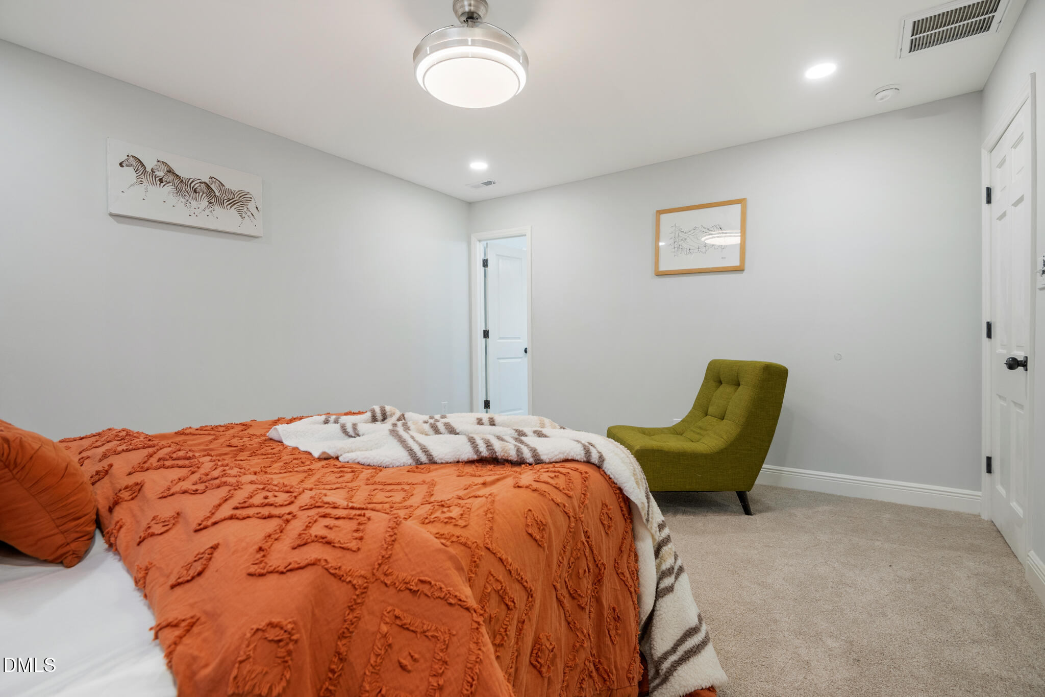 6604 Winding Trail Raleigh, NC 27612 - Photo 27 of 49 a bedroom with a bed and a chair