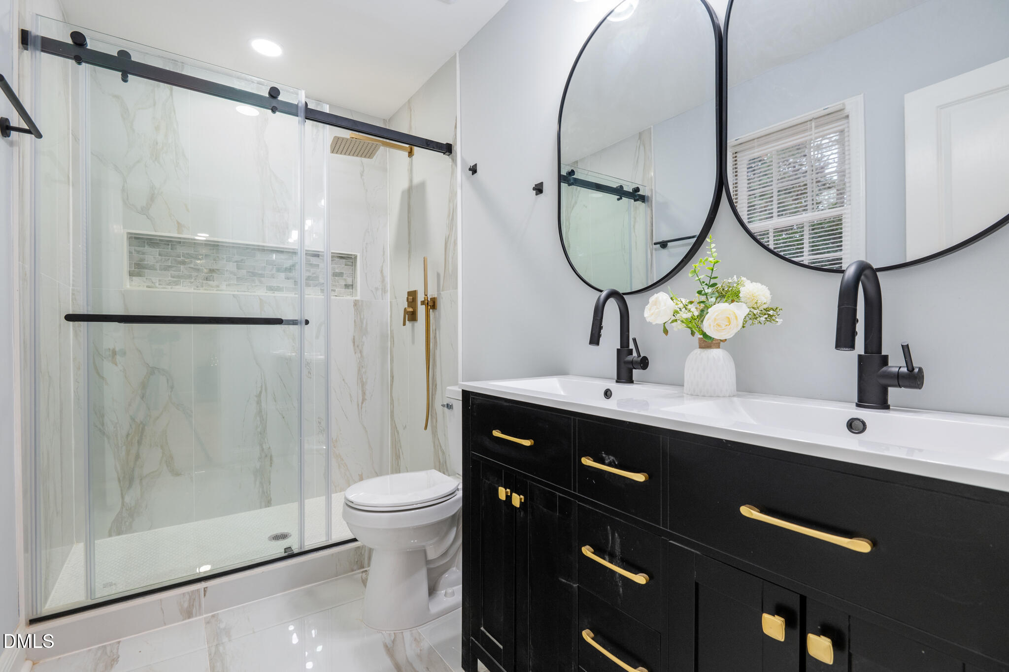 6604 Winding Trail Raleigh, NC 27612 - Photo 29 of 49 a bathroom with a sink a toilet and a mirror