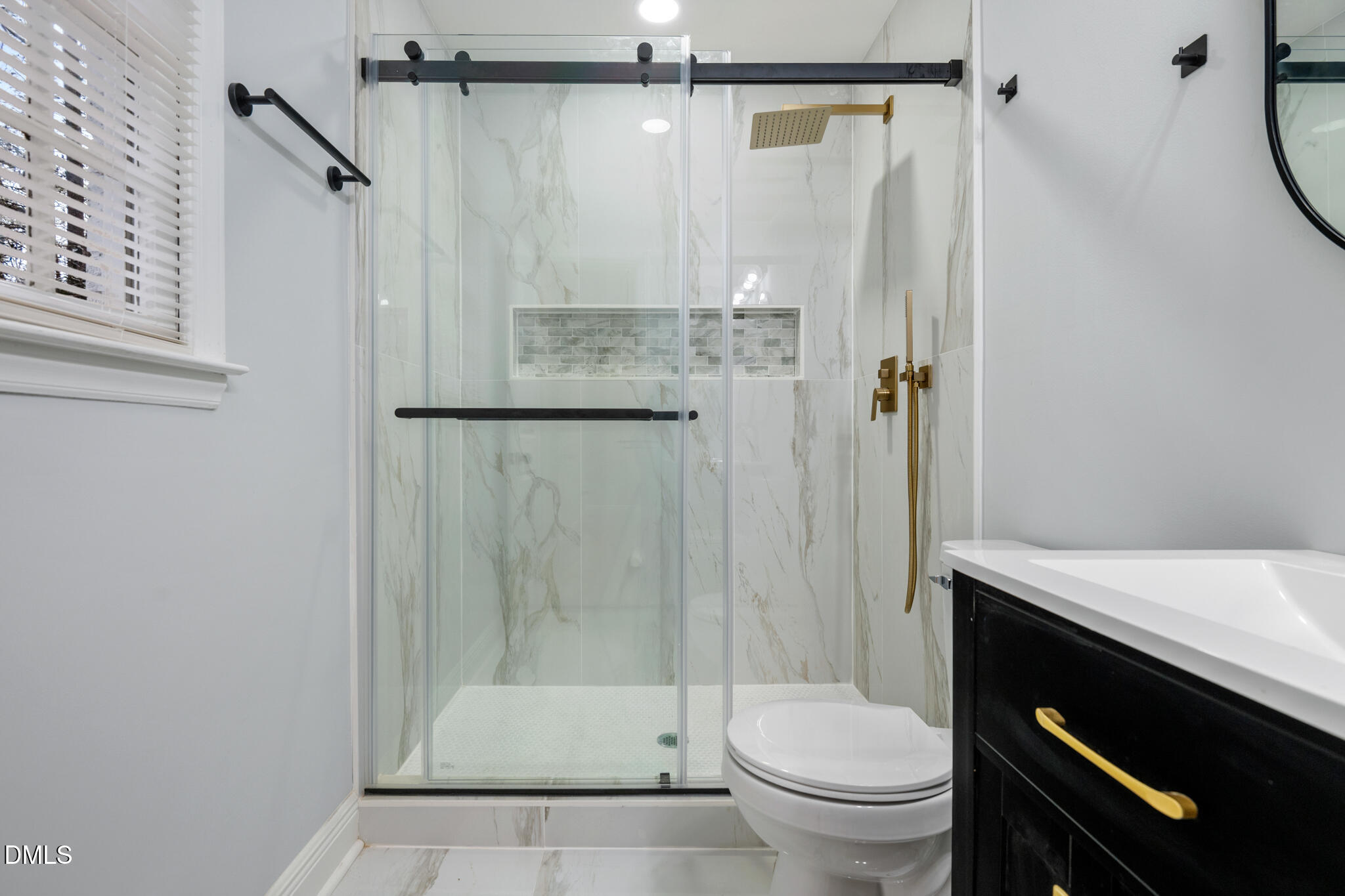 6604 Winding Trail Raleigh, NC 27612 - Photo 30 of 49 a bathroom with a sink a toilet and shower