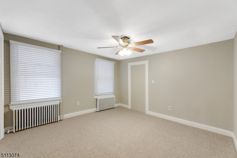 2 Center Street Madison, NJ 07940 - Photo 15 of 18 an empty room with a window and a ceiling fan