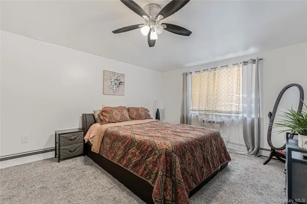 a bedroom with a large bed and a large window
