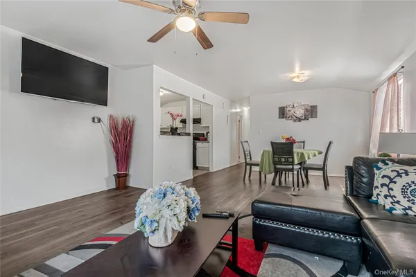 a dining room with furniture entryway and wooden floor