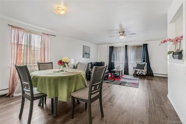 a view of a dining room with furniture and wooden floor