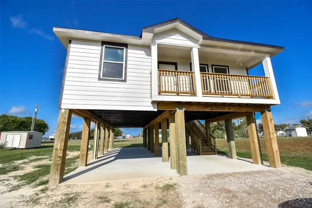 a view of a house with wooden fence