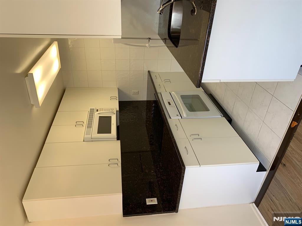 153 Park Avenue, Unit 153C Park Ridge, NJ 07656 - Photo 13 of 21 a kitchen with a sink and a stove top oven