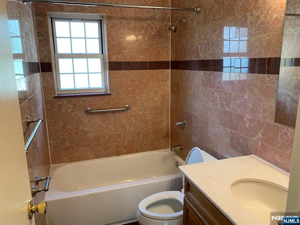 153 Park Avenue, Unit 153C Park Ridge, NJ 07656 - Photo 15 of 21 a bathroom with a sink a toilet and shower