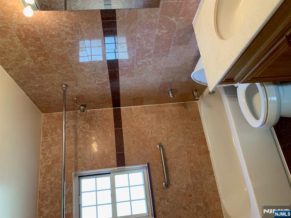 153 Park Avenue, Unit 153C Park Ridge, NJ 07656 - Photo 16 of 21 a bathroom with a sink a toilet and shower