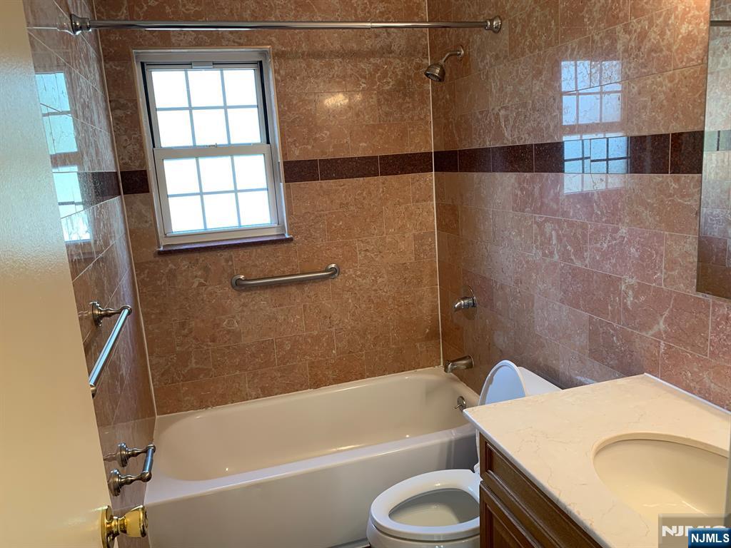 153 Park Avenue, Unit 153C Park Ridge, NJ 07656 - Photo 17 of 21 a bathroom with a granite countertop bathtub sink vanity and toilet