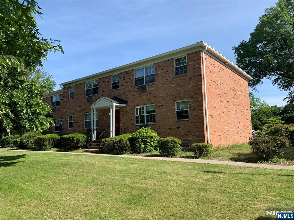 153 Park Avenue, Unit 153C Park Ridge, NJ 07656 - Photo 20 of 21 a front view of a house with a yard