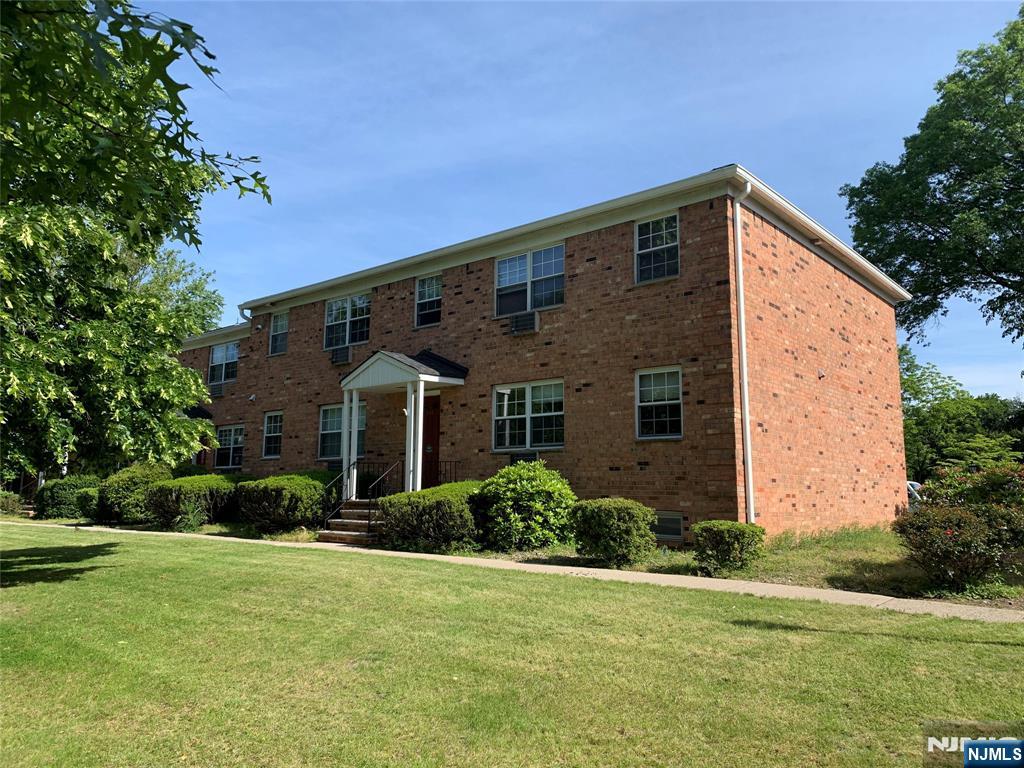 153 Park Avenue, Unit 153C Park Ridge, NJ 07656 - Photo 2 of 21 a front view of house with yard and green space