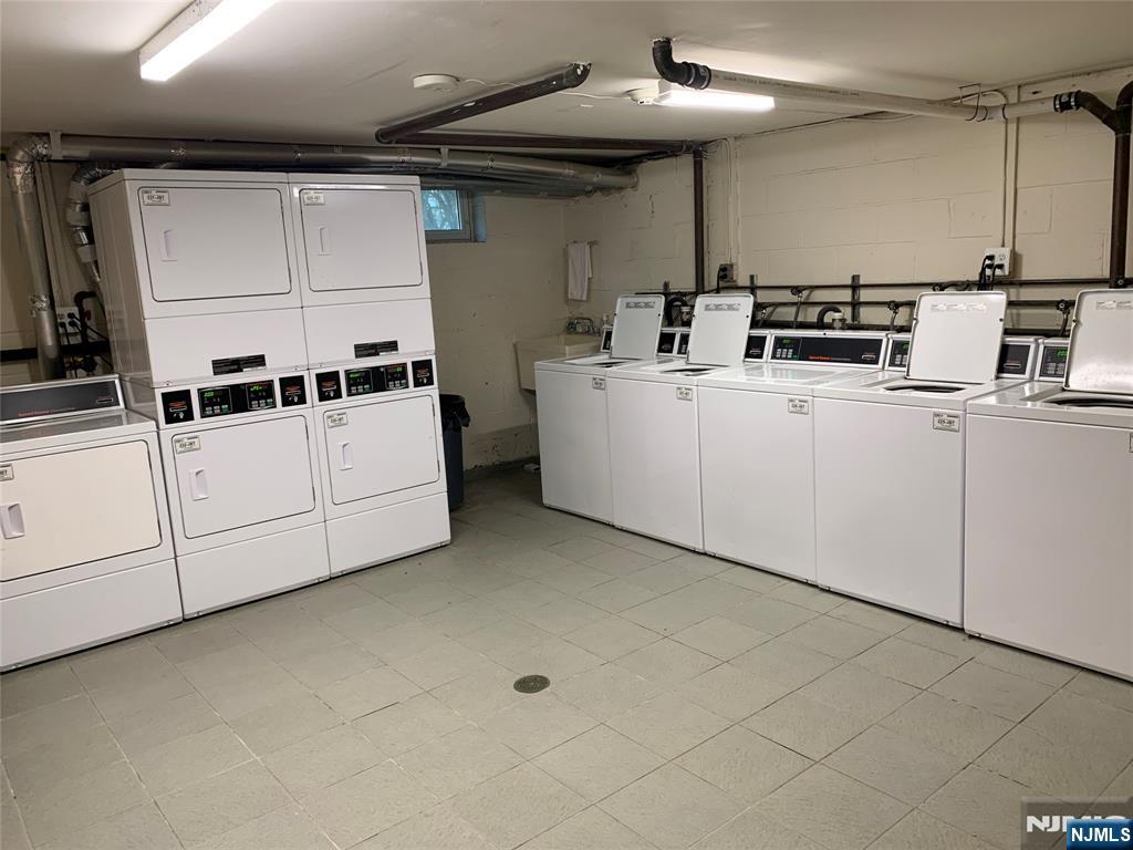 153 Park Avenue, Unit 153C Park Ridge, NJ 07656 - Photo 6 of 21 a kitchen with cabinets and white appliances