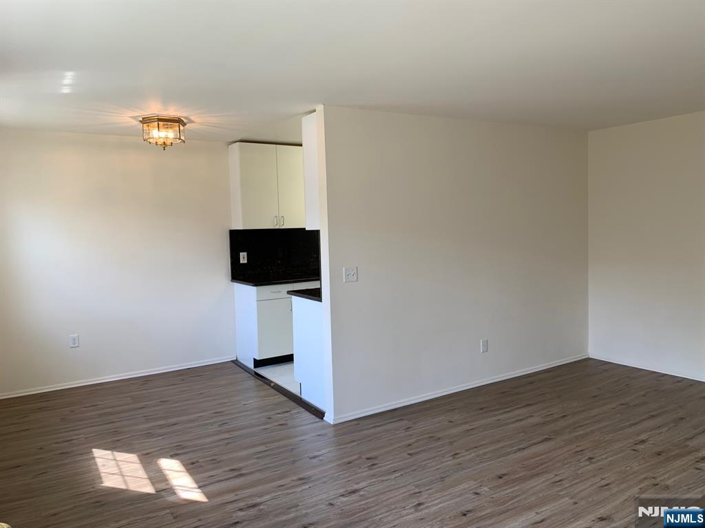 153 Park Avenue, Unit 153C Park Ridge, NJ 07656 - Photo 9 of 21 a view of a livingroom with wooden floor