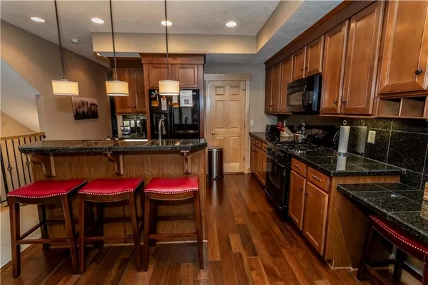 a kitchen with sink cabinets and wooden floor