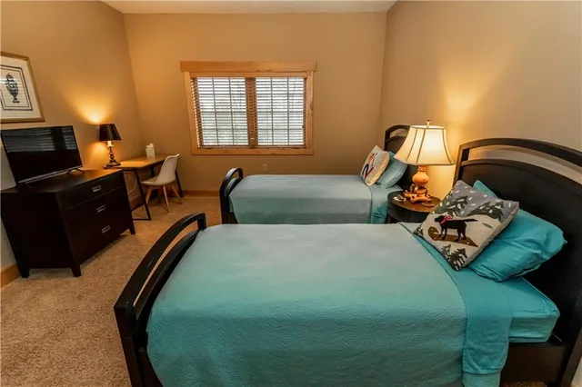 a bathroom with a sink a toilet a mirror and shower