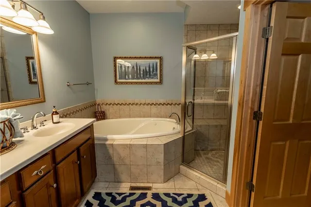 a bathroom with a bathtub and a shower