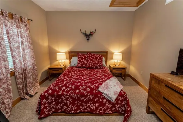 a bedroom with bed and a window