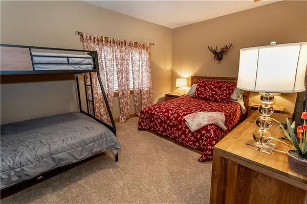 a bedroom with a bed a lamp and a window