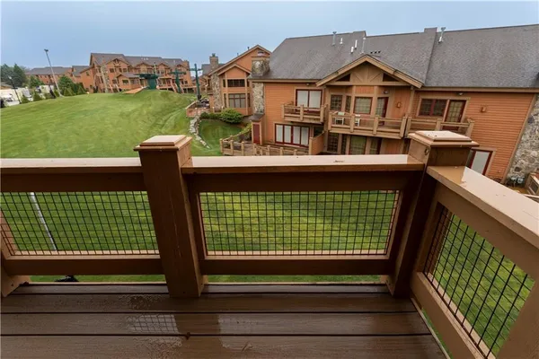 a view of a house with a big yard and large trees
