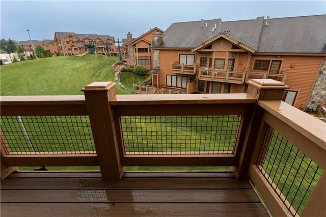 a view of a house with a big yard and large trees