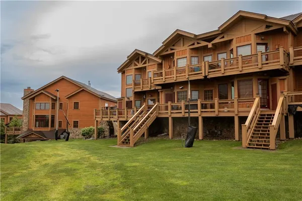 a view of a house with a big yard and potted plants