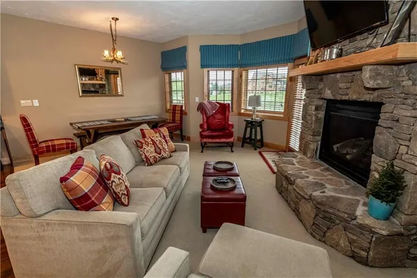 a living room with furniture and kitchen view