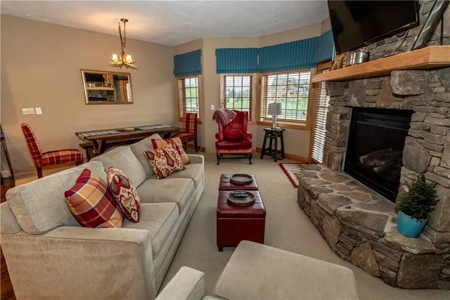 a living room with furniture and kitchen view