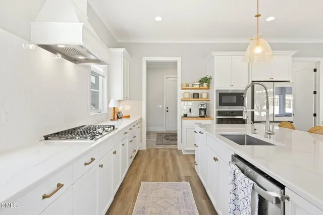 a dining room with furniture a chandelier and wooden floor