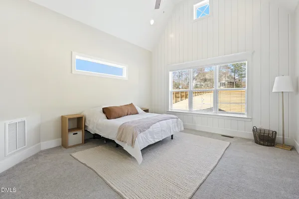 a bedroom with a bed and a lamp