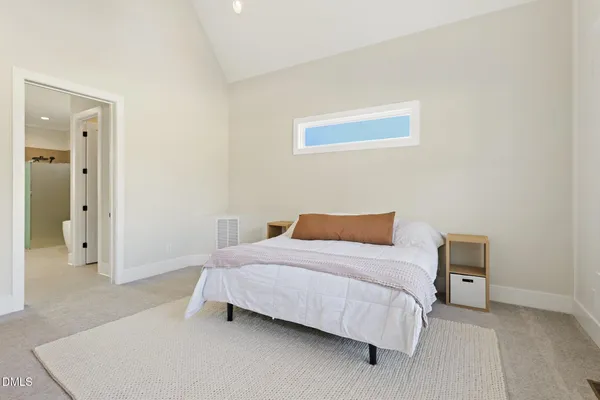 a bedroom with a bed and a dresser