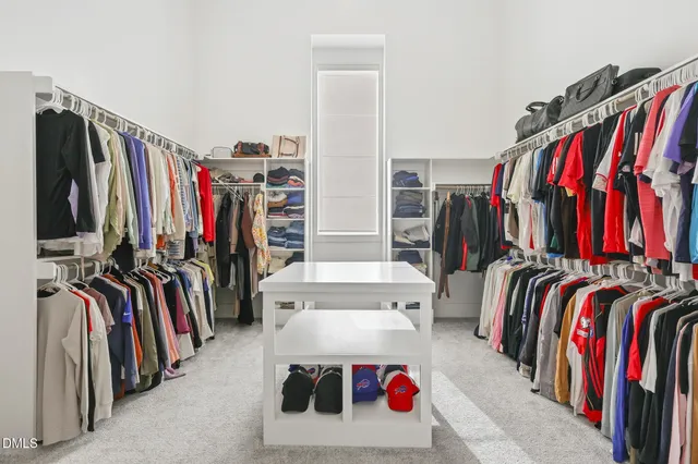 a spacious bedroom with a bed and a window