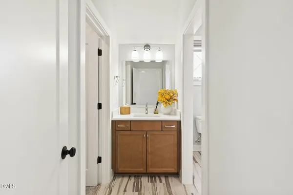 a bathroom with a sink vanity and a mirror