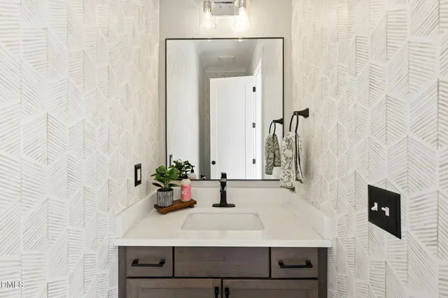 a living room with furniture and a large mirror