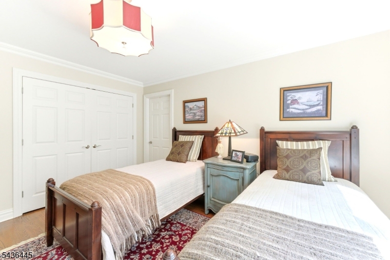 4 Windemere Way Sparta, NJ 07871 - Photo 29 of 50 a bedroom with a bed and a painting on the wall