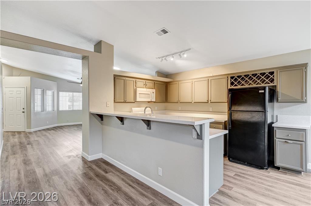 2283 Ramsgate Drive Henderson, NV 89074 - Photo 51 of 51 An open floorplan seamlessly connects the functional kitchen to the adjoining living space.