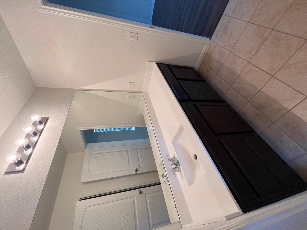 516 East Slaughter Lane, Unit 1404 Austin, TX 78744 - Photo 14 of 17 a bathroom with a double vanity sink a and mirror
