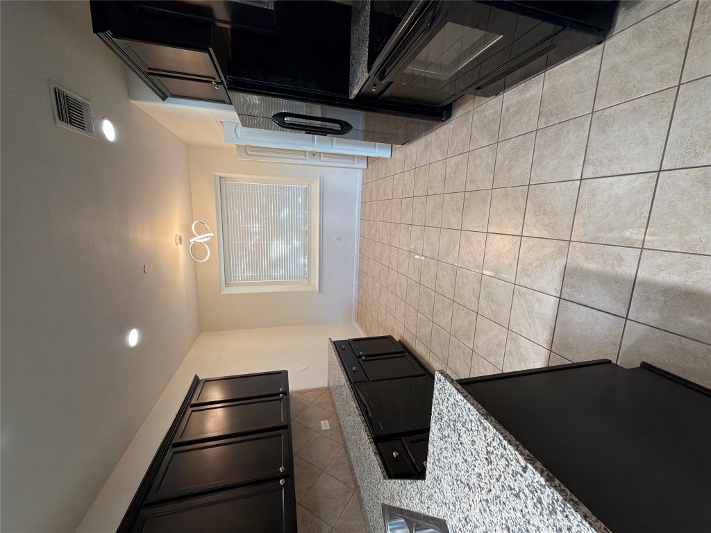 516 East Slaughter Lane, Unit 1404 Austin, TX 78744 - Photo 3 of 17 a kitchen with a sink a stove and a microwave