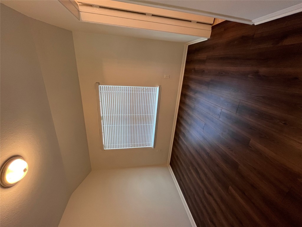 516 East Slaughter Lane, Unit 1404 Austin, TX 78744 - Photo 5 of 17 a view of an empty room with wooden floor and a window